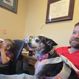 The person lying on the sofa with his pet